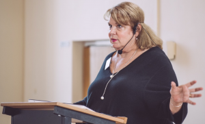 Dr. Roman speaking at a conference